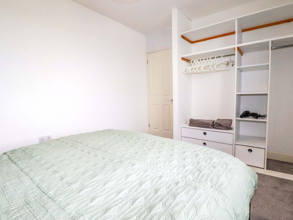 A bedroom with a bed and wardrobe at Trelowen in Trenance