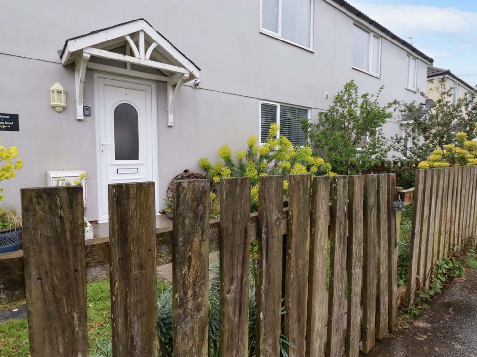 An entrance with a front door and wooden fence at Trelowen in Trenance