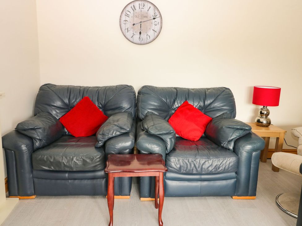 A living room with a sofa and table at Daisy Nook in Hull