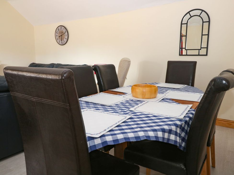 A dining room with a table and chairs at Daisy Nook in Hull
