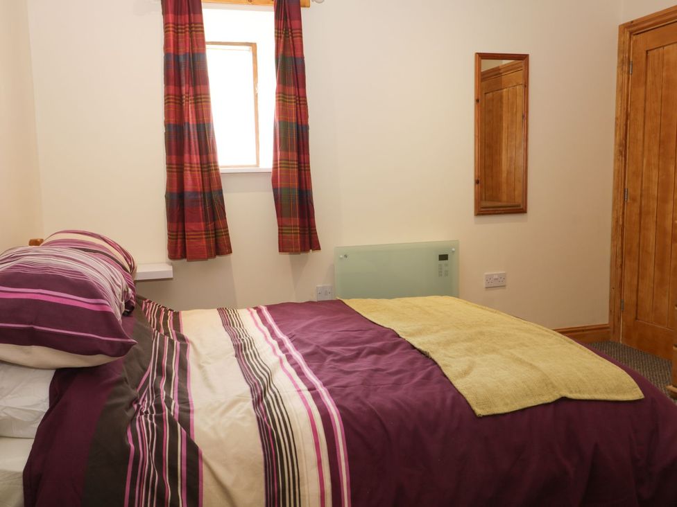 A bedroom with a bed and mirror at Daisy Nook in Hull