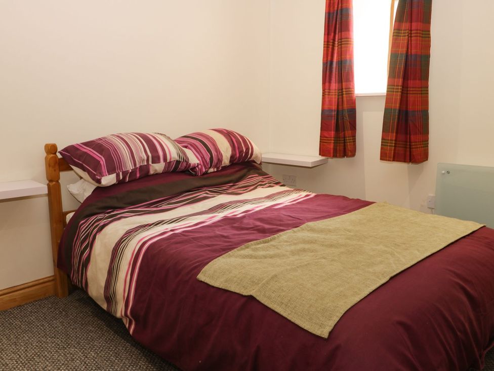 A bedroom with a bed and curtains at Daisy Nook in Hull
