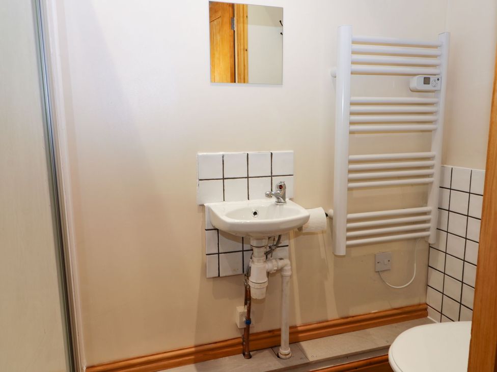 A bathroom with a sink and heated towel rail at Daisy Nook in Hull