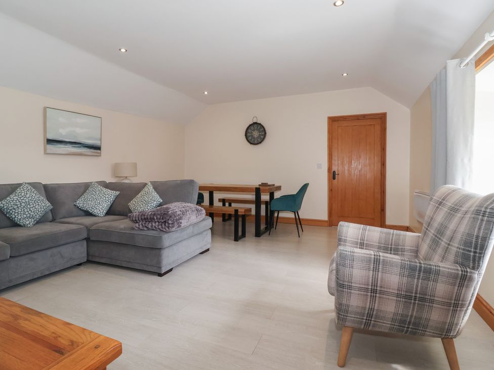 A living room with a sofa and table at Daisy Nook in Withernsea