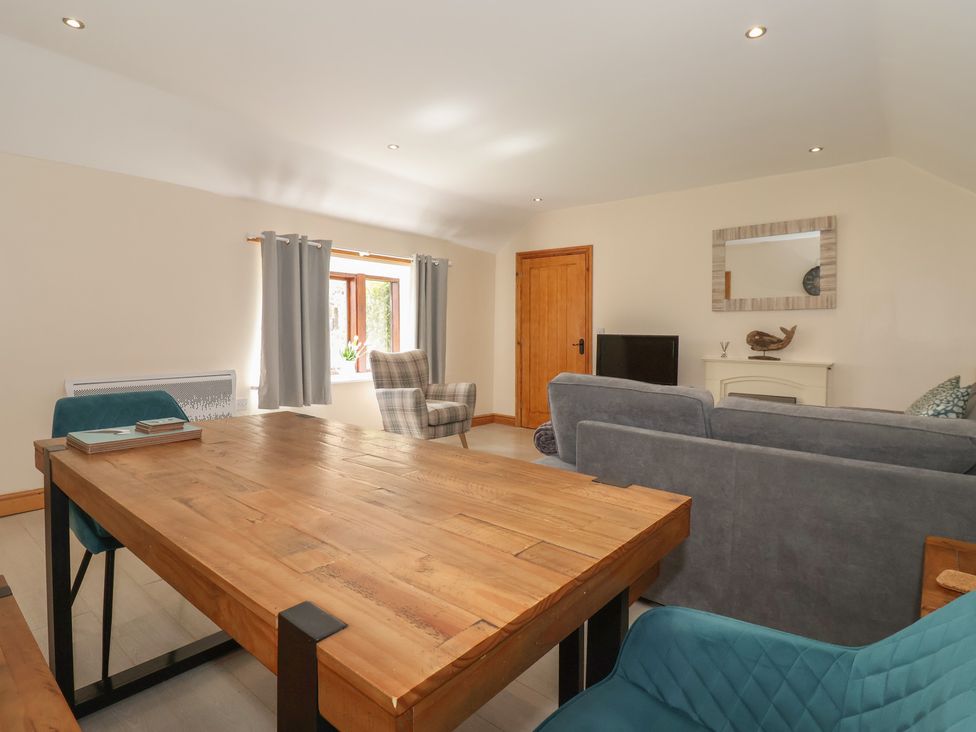 A living room with a table and chairs at Daisy Nook in Withernsea