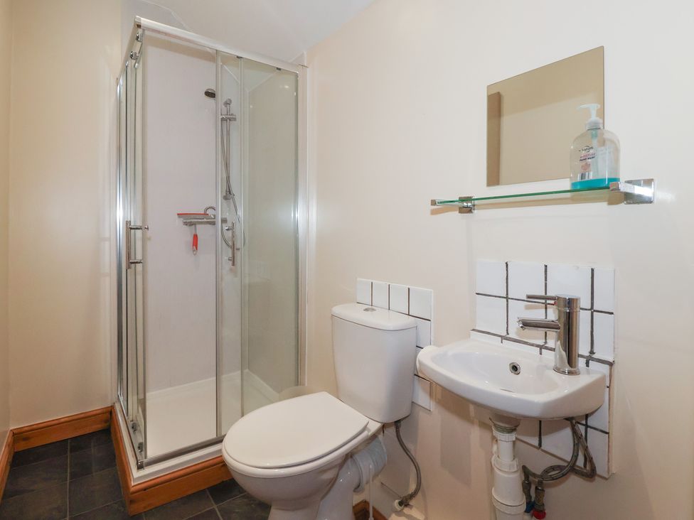 A bathroom with a shower toilet and sink at Daisy Nook in Withernsea