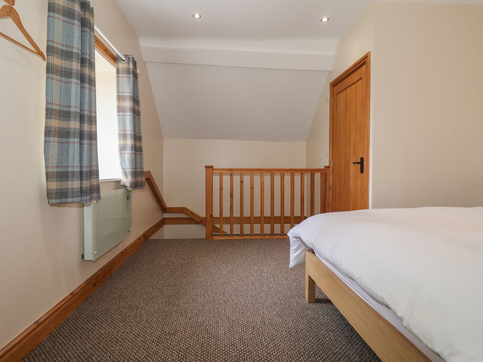 A bedroom with a staircase and door at Daisy Nook in Withernsea