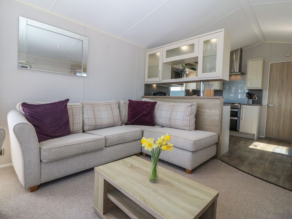 A living room with a sofa and coffee table at Pheasant Lodge Holyhead