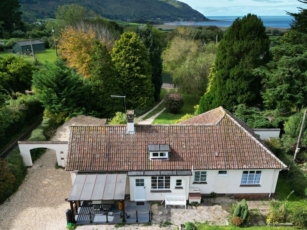 An overview of a house with a patio and garden at Barton Lodge in Porlock