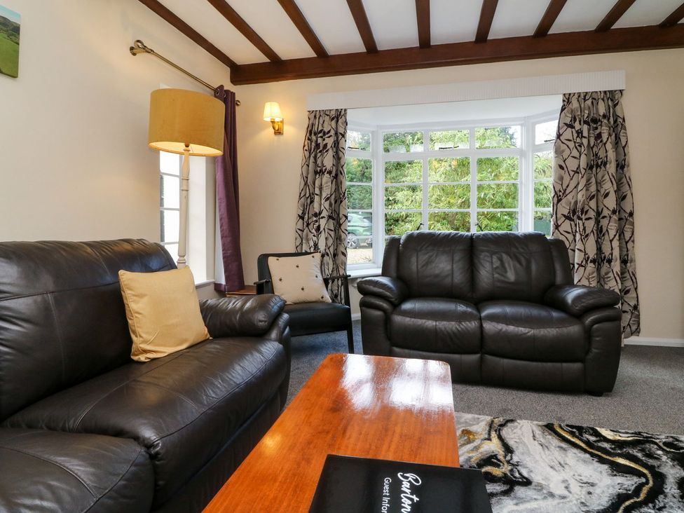 A living room with a sofa and coffee table at Barton Lodge Porlock