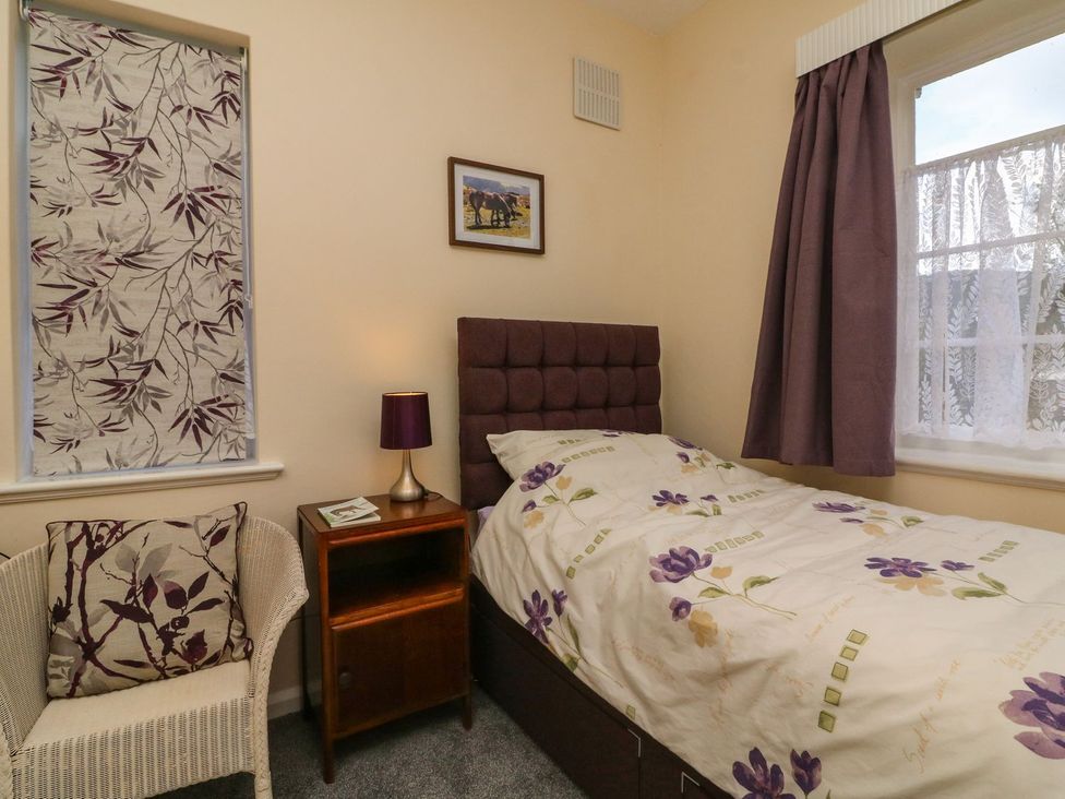 A bedroom with a single bed and window at Barton Lodge in Porlock