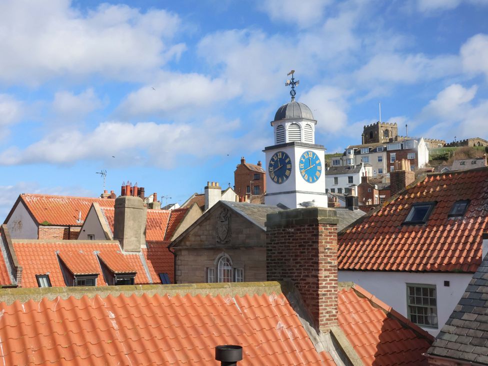 A view of rooftops and a clock tower at The Four Views in Whitby