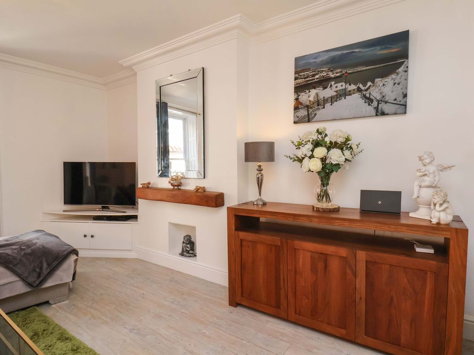A living room with a television and console table at The Four Views in Whitby