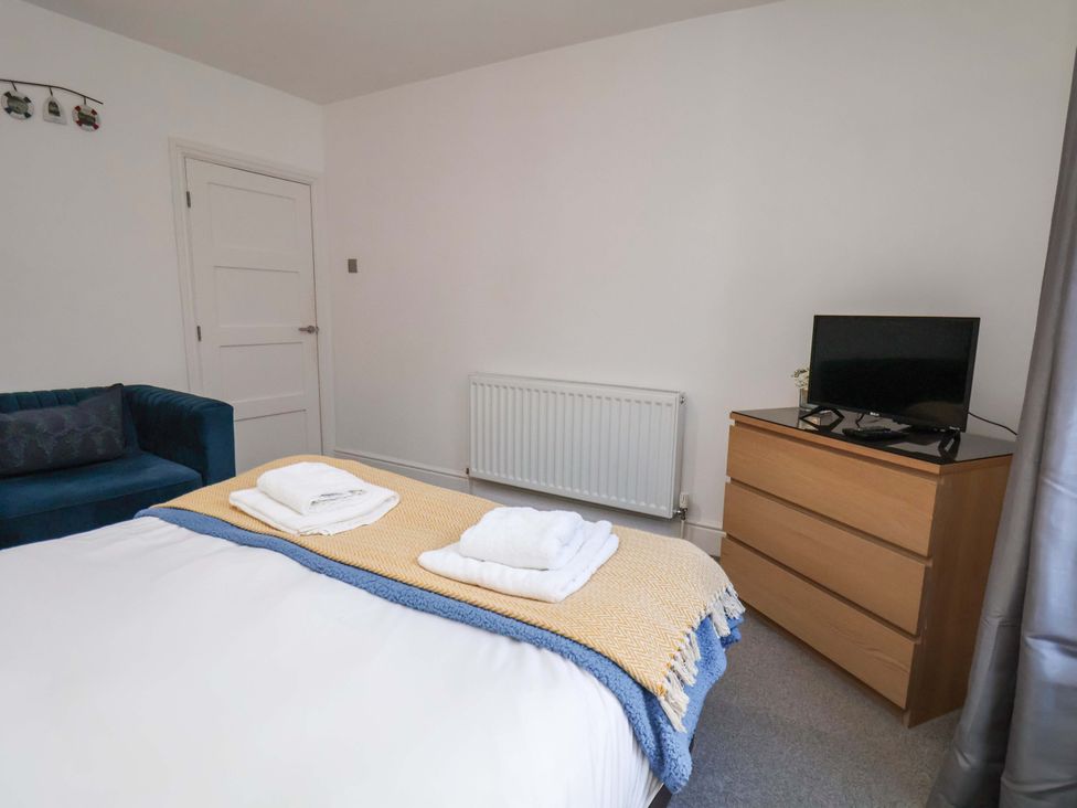 A bedroom with a bed and television at The Four Views in Whitby