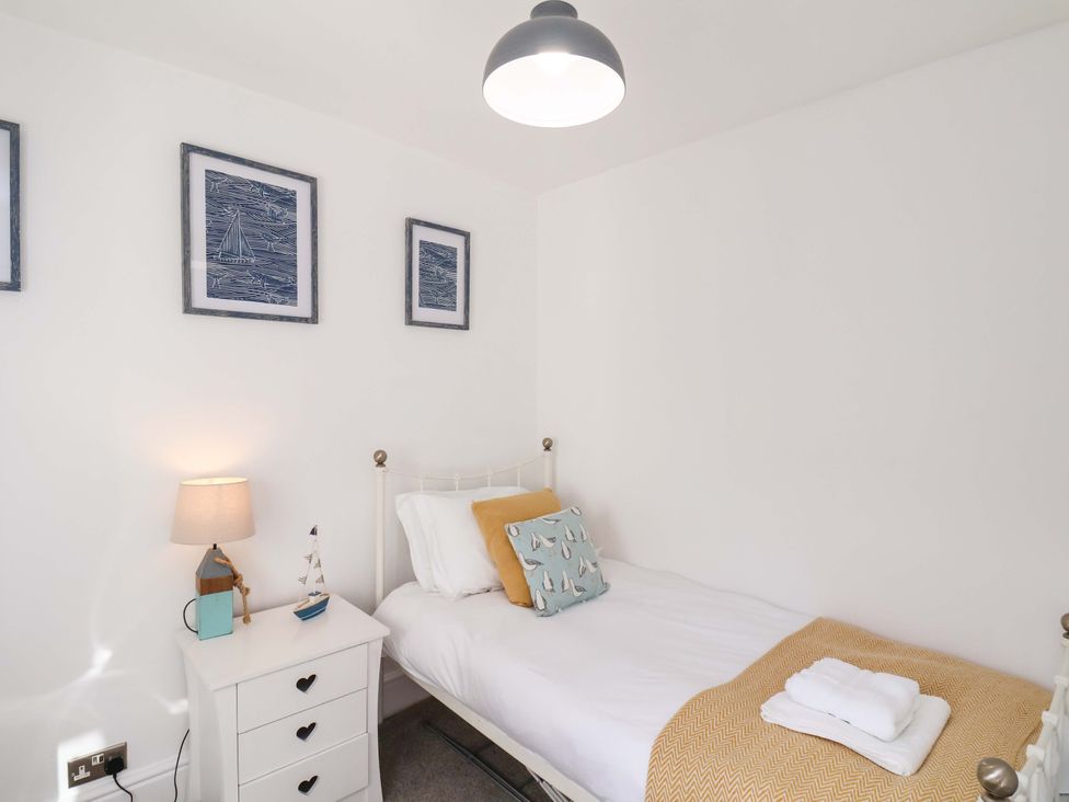 A bedroom with a single bed and a nightstand at The Four Views in Whitby