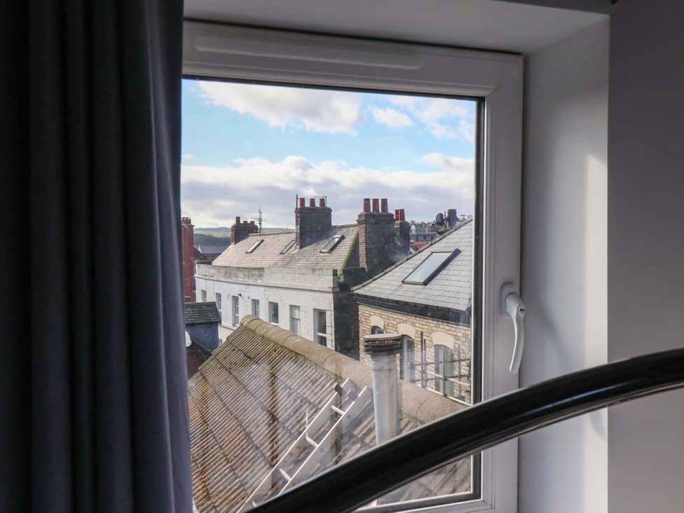 A view from a window showing rooftops and chimneys at The Four Views in Whitby