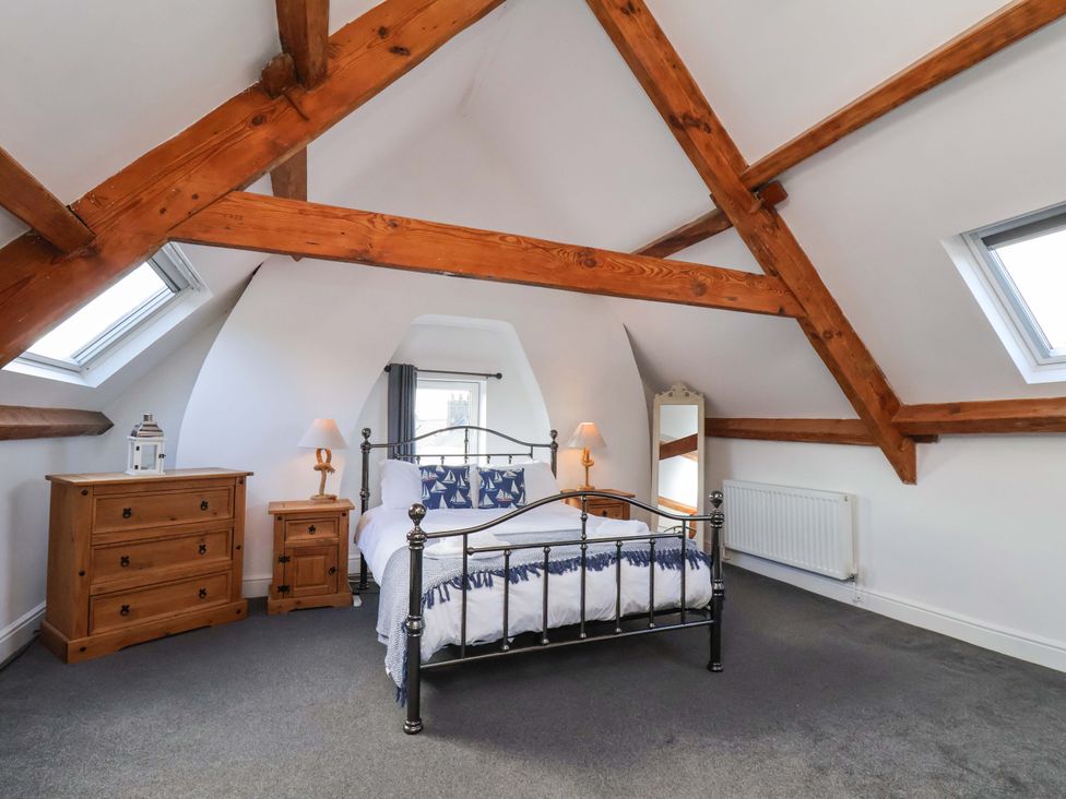 A bedroom with a bed and furniture at The Four Views in Whitby