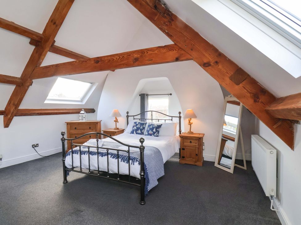 A bedroom with a bed and furniture at The Four Views in Whitby
