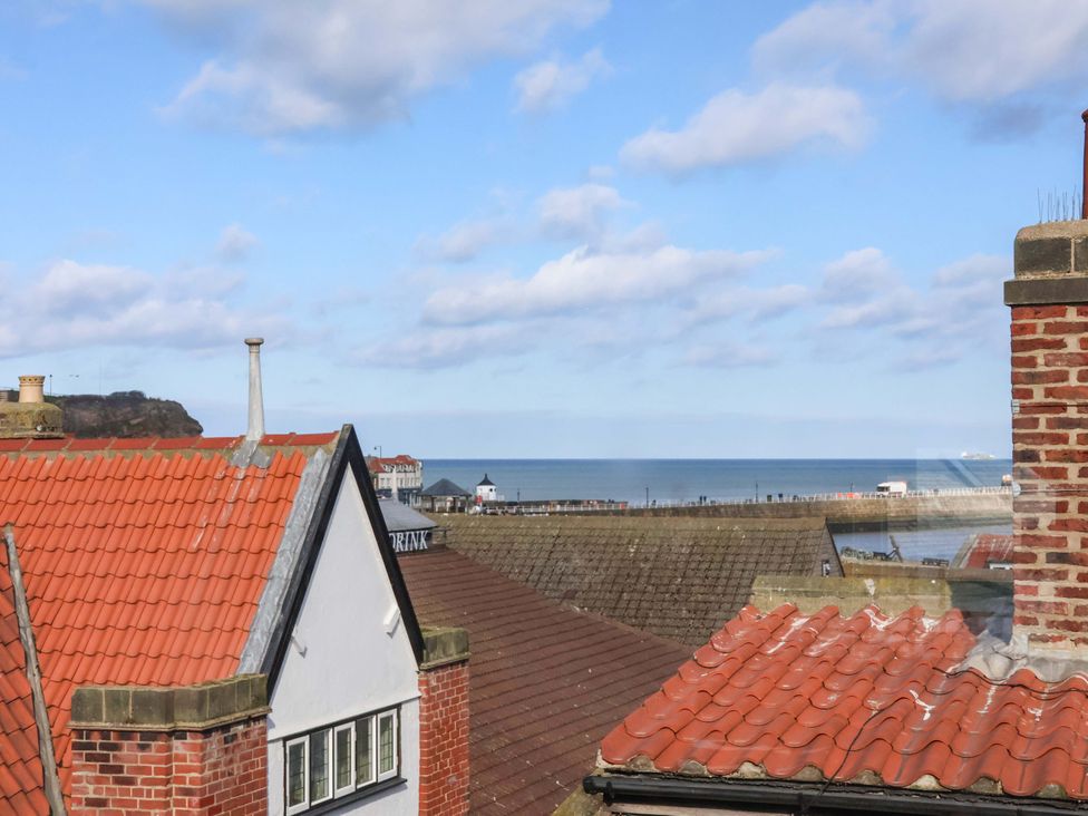 A view of rooftops and sea from an elevated position at The Four Views in Whitby