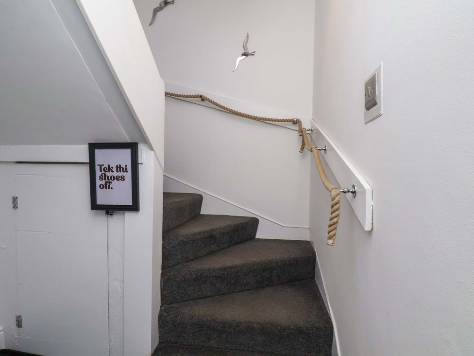A staircase with a handrail and a sign at The Four Views in Whitby