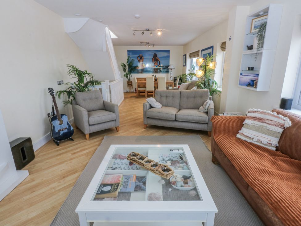 A living room with sofas and a dining area at Snowdonia View in Pwllheli