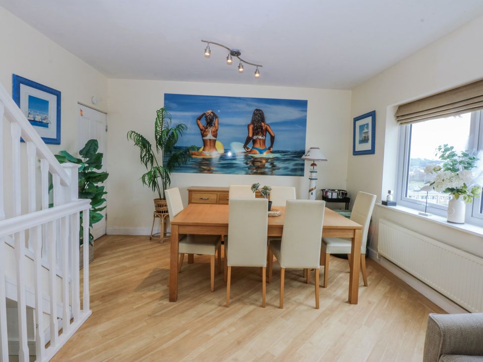 A dining room with a table and chairs at Snowdonia View in Pwllheli
