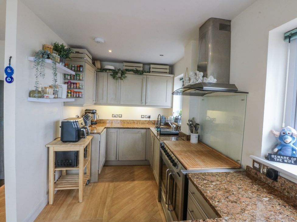 A kitchen with cabinets, counter space, and a stove at Snowdonia View in Pwllheli