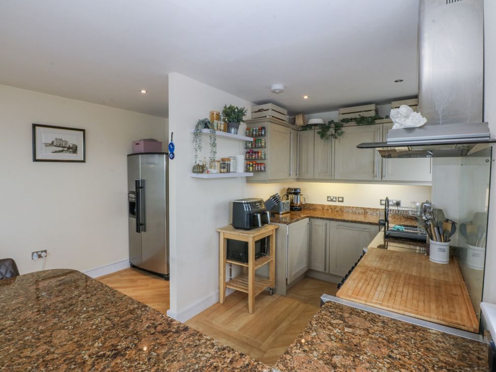 A kitchen with modern appliances and wooden countertops at Snowdonia View in Pwllheli