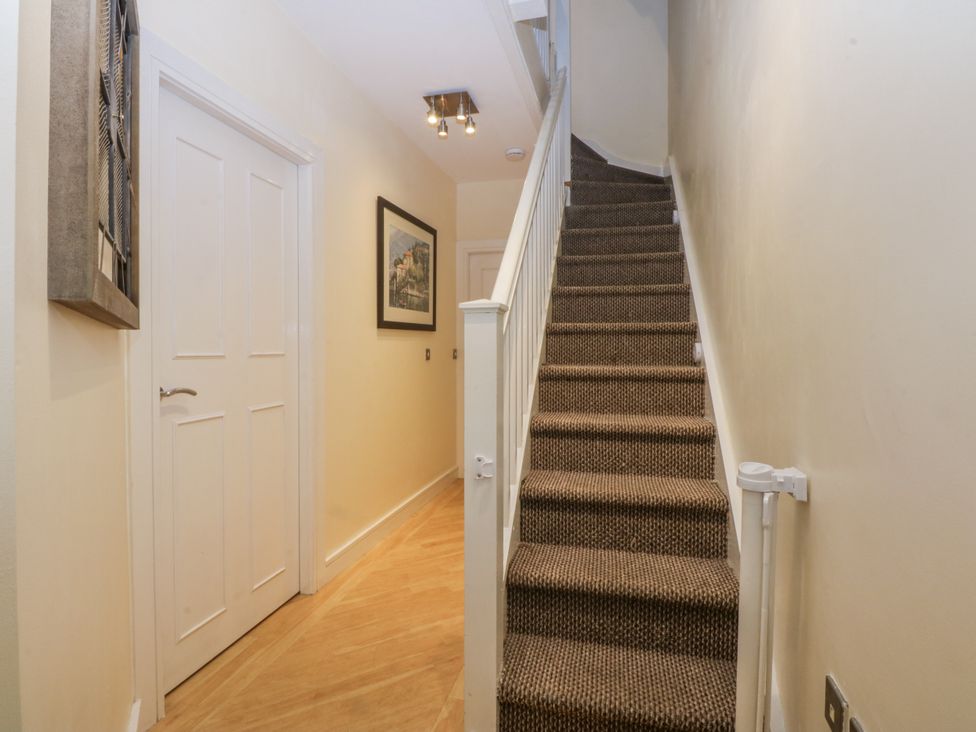 A hallway with a staircase and a door at Snowdonia View in Pwllheli