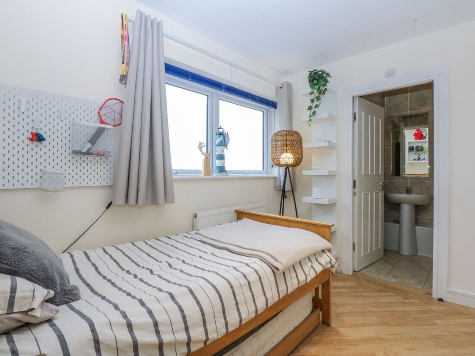 A bedroom with a bed and an ensuite bathroom at Snowdonia View in Pwllheli