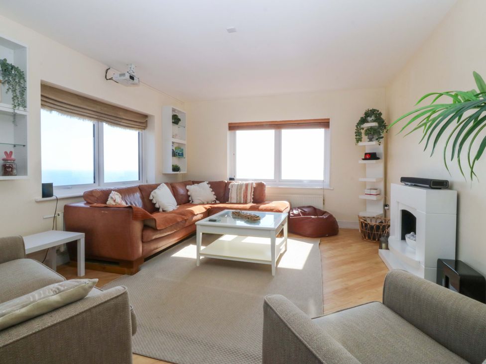A living room with a sofa and coffee table at Snowdonia View in Pwllheli