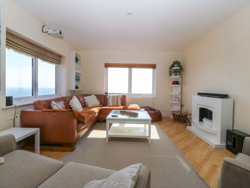 A living room with a sofa and coffee table at Snowdonia View in Pwllheli