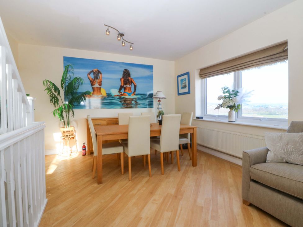 A dining room with a table and chairs at Snowdonia View in Pwllheli