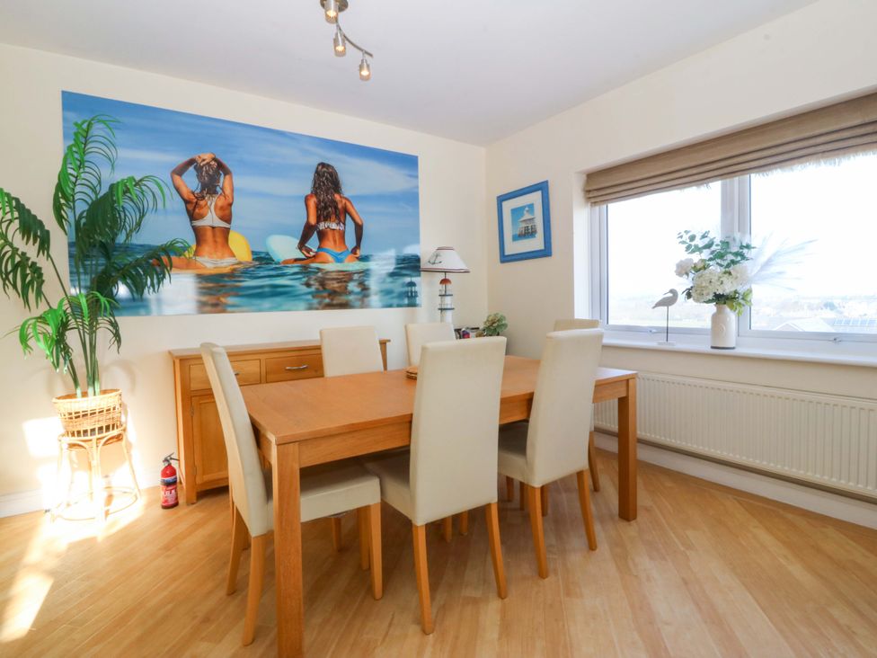 A dining room with a table and chairs at Snowdonia View in Pwllheli