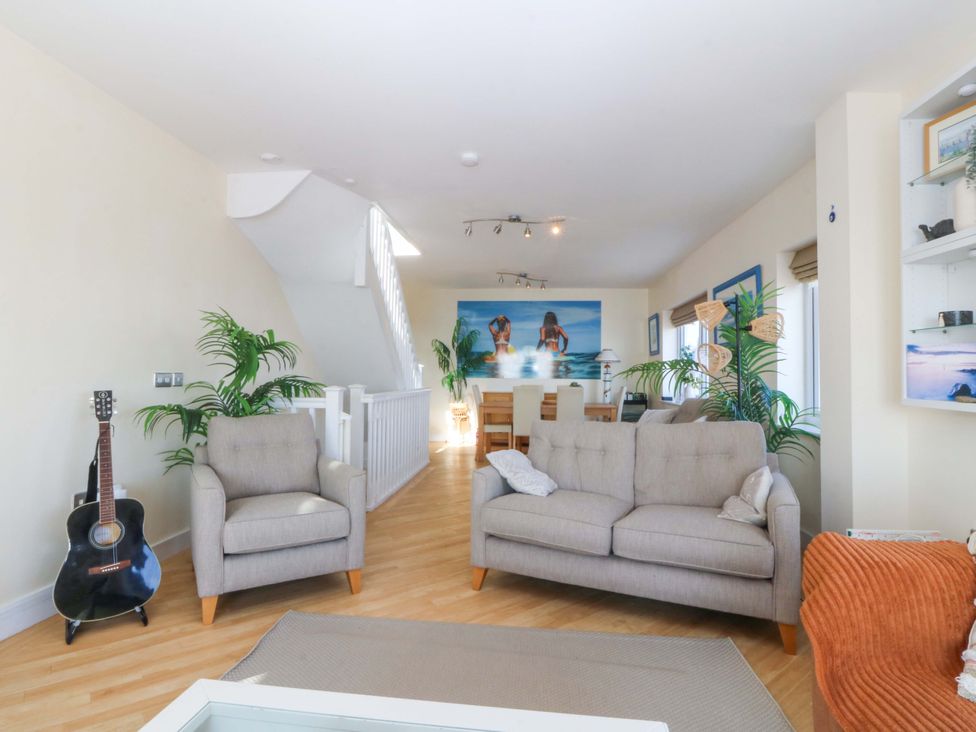 A living room with sofas and a dining area at Snowdonia View in Pwllheli