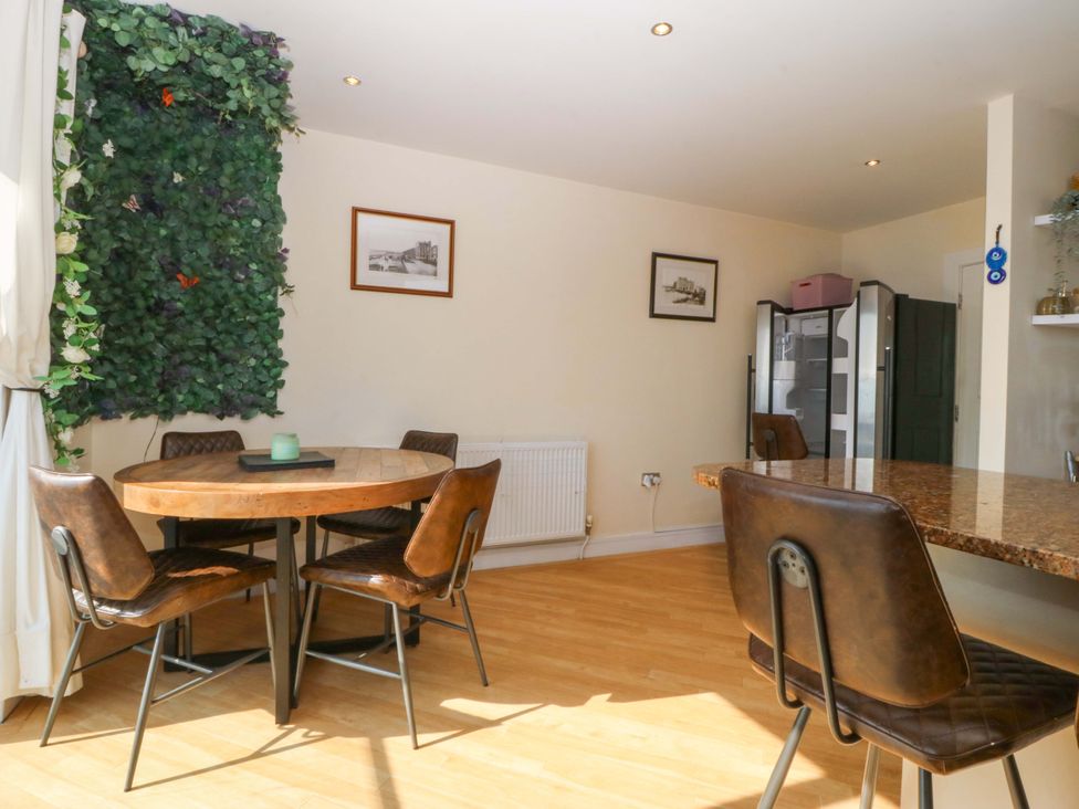 A dining room with a table and chairs at Snowdonia View in Pwllheli