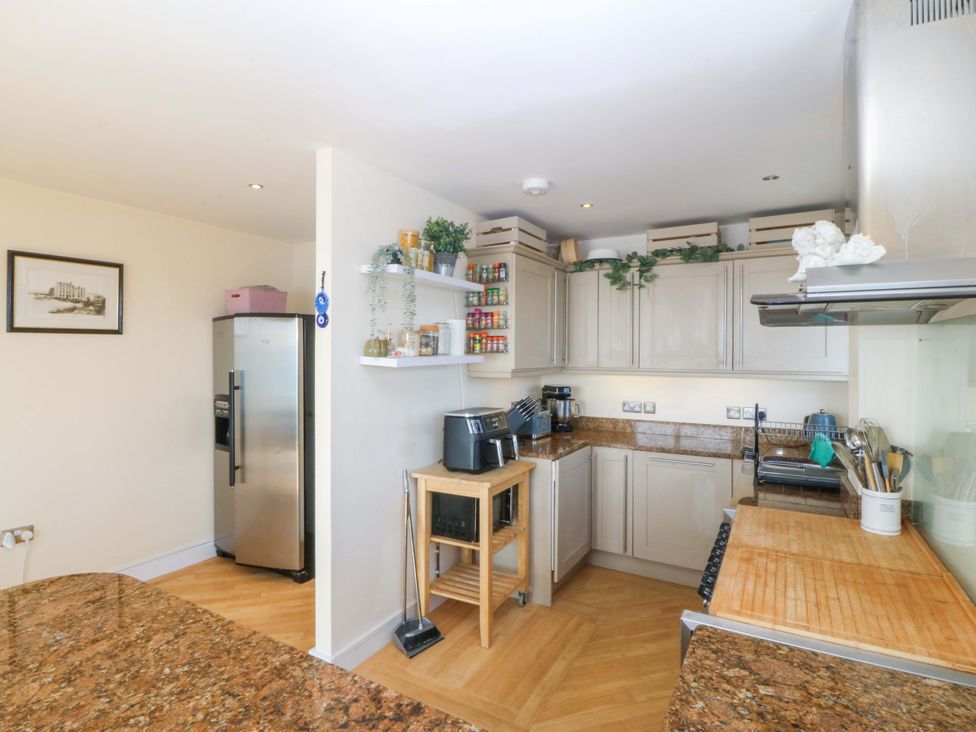 A kitchen with a refrigerator and countertop at Snowdonia View in Pwllheli