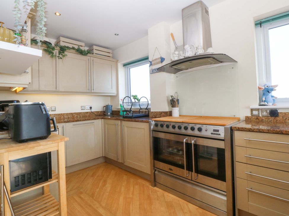 A kitchen with cabinets, oven, and countertop at Snowdonia View in Pwllheli