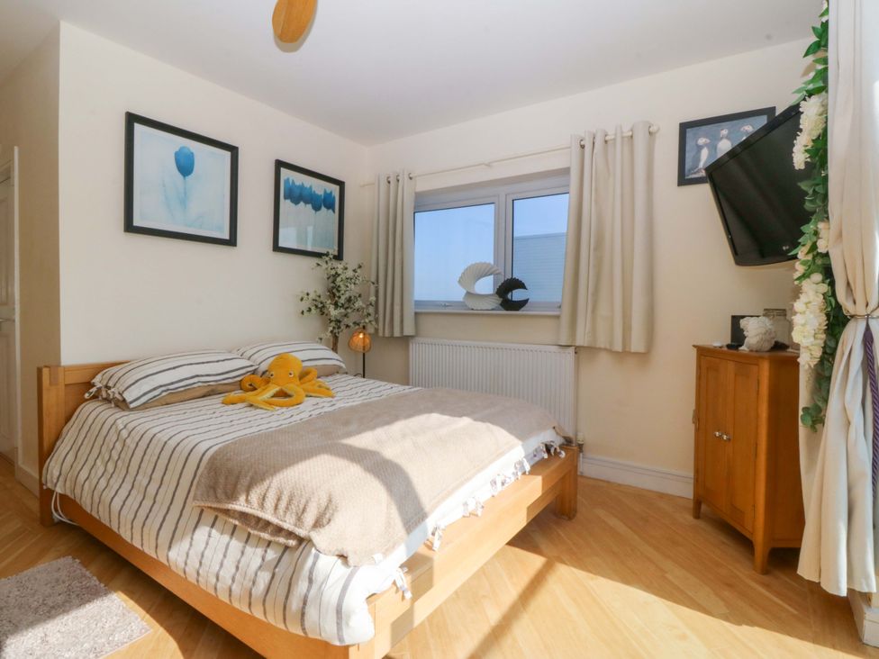 A bedroom with a bed and a dresser at Snowdonia View in Pwllheli