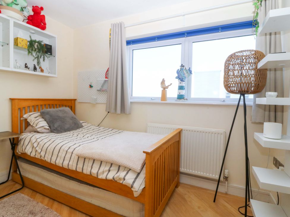 A bedroom with a bed and window at Snowdonia View in Pwllheli