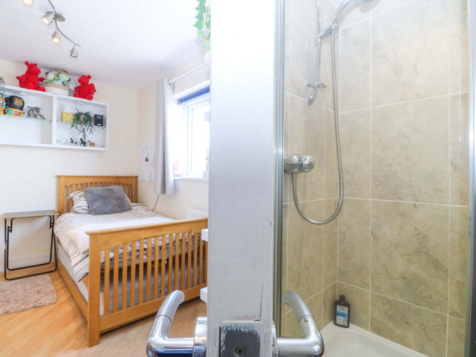 A bedroom with a bed and a shower at Snowdonia View in Pwllheli