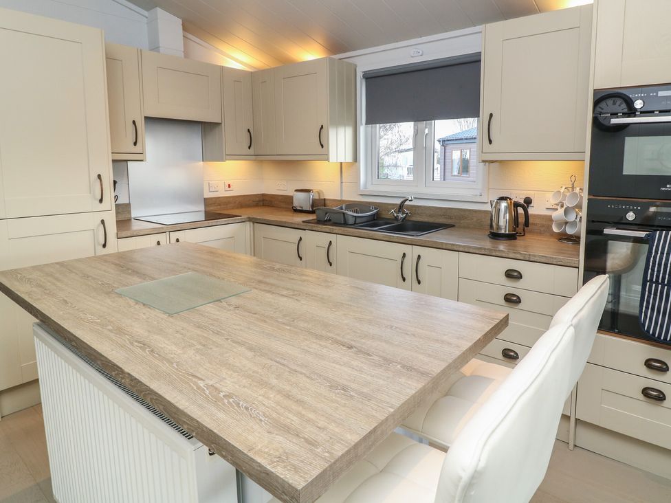 A kitchen with cabinets and island at Fairways 22 in Lincoln