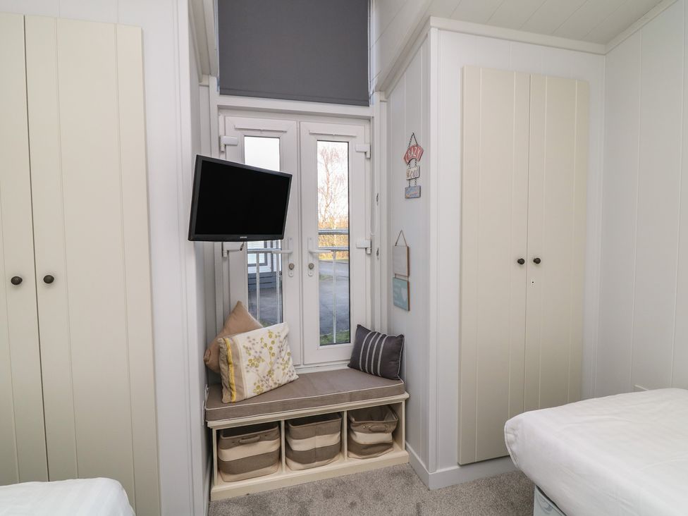 A bedroom with a television and window at Fairways 22 in Lincoln