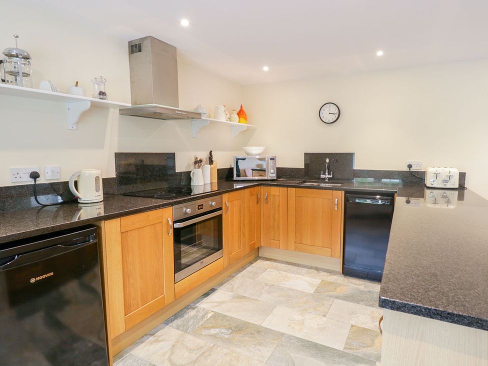 A kitchen with appliances and a counter at Plas Tirion Cottage in Holywell