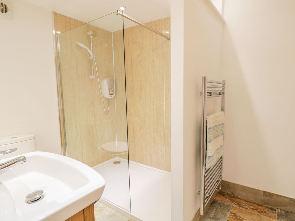 A bathroom with a shower and sink at Plas Tirion Cottage Holywell