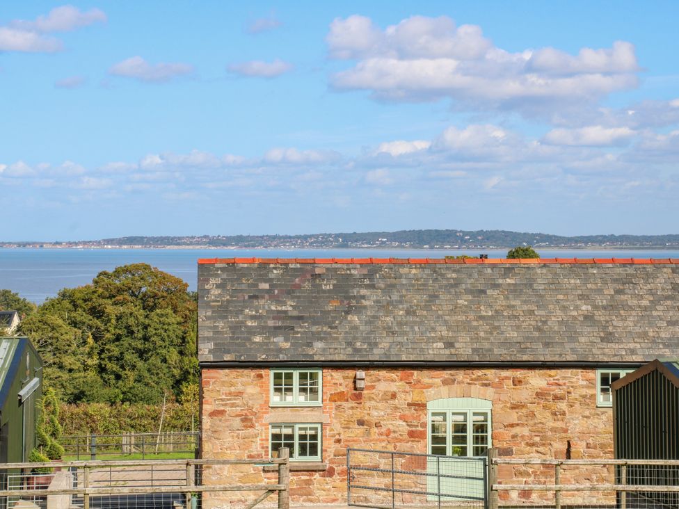 A building with a slate roof and windows at Plas Tirion Cottage Mostyn near Holywell