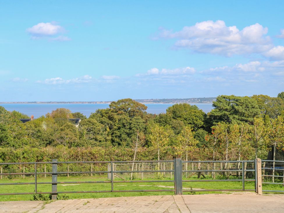 A view of a lake and surrounding greenery at Plas Tirion Cottage Mostyn near Holywell