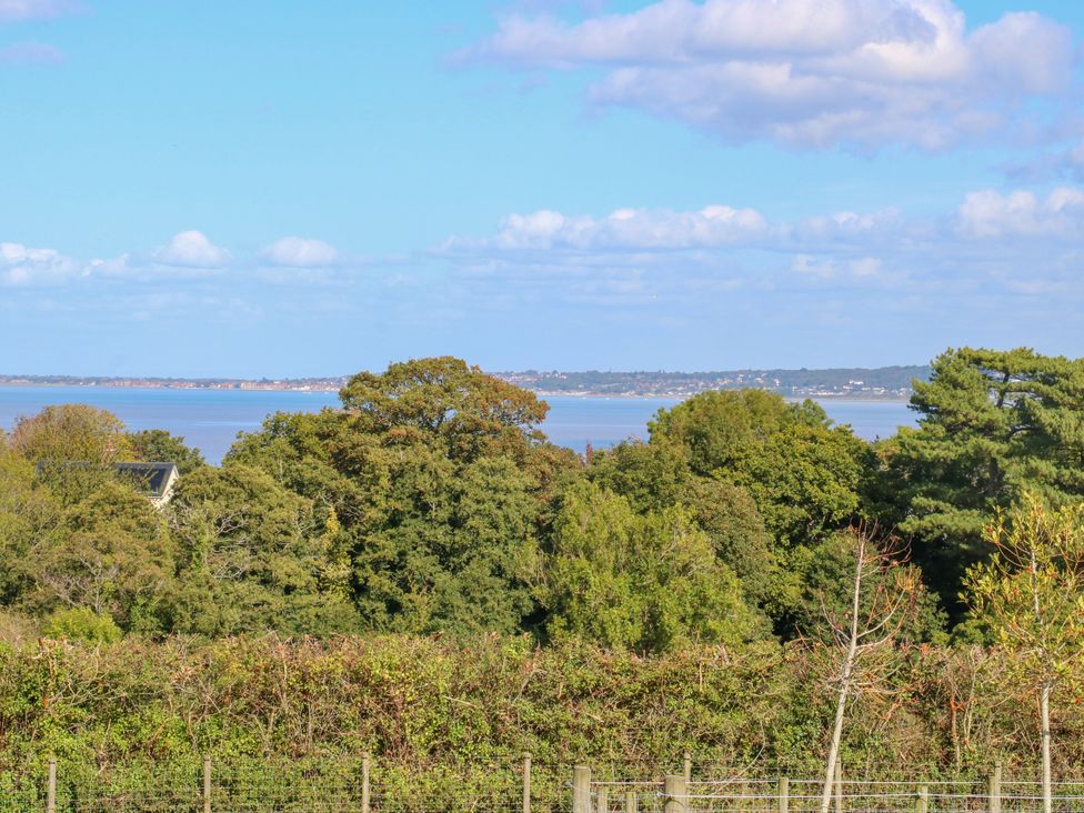 A view showing trees and water at Plas Tirion Cottage Mostyn near Holywell