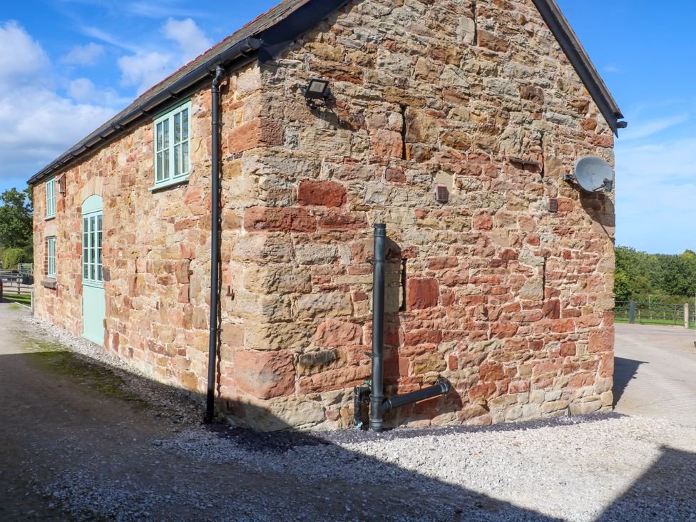 A stone exterior with windows and a door at Plas Tirion Cottage Mostyn near Holywell