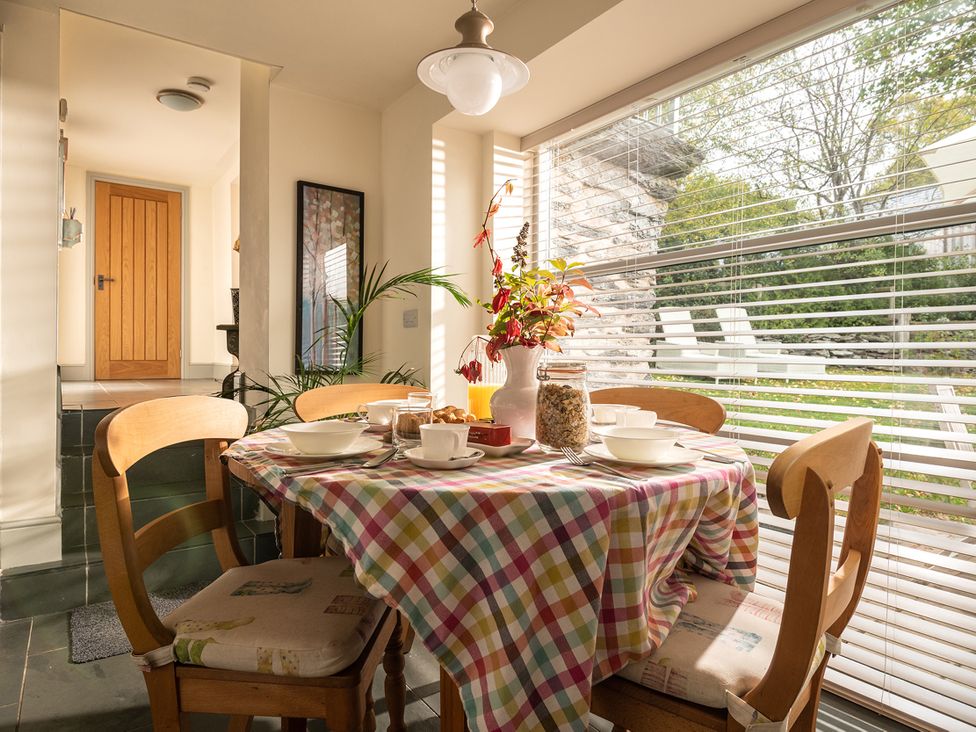 A kitchen with a table set up for breakfast at Shepherds Cottage in Llandrillo